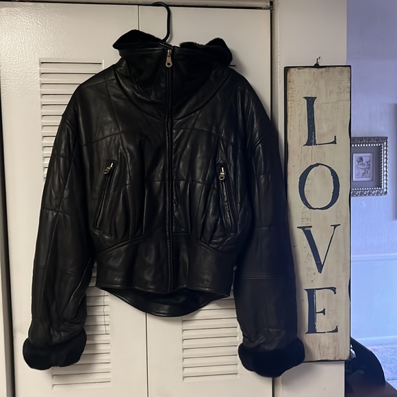 Thick and cozy black leather jacket with fur around the color and wrists. - Picture 3 of 4